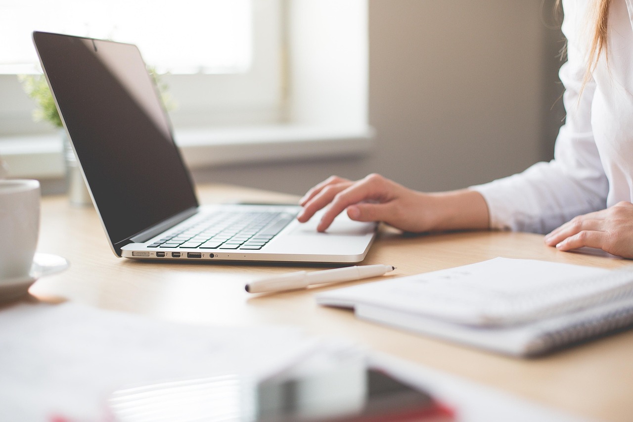 Close up image of an employee working on a laptop