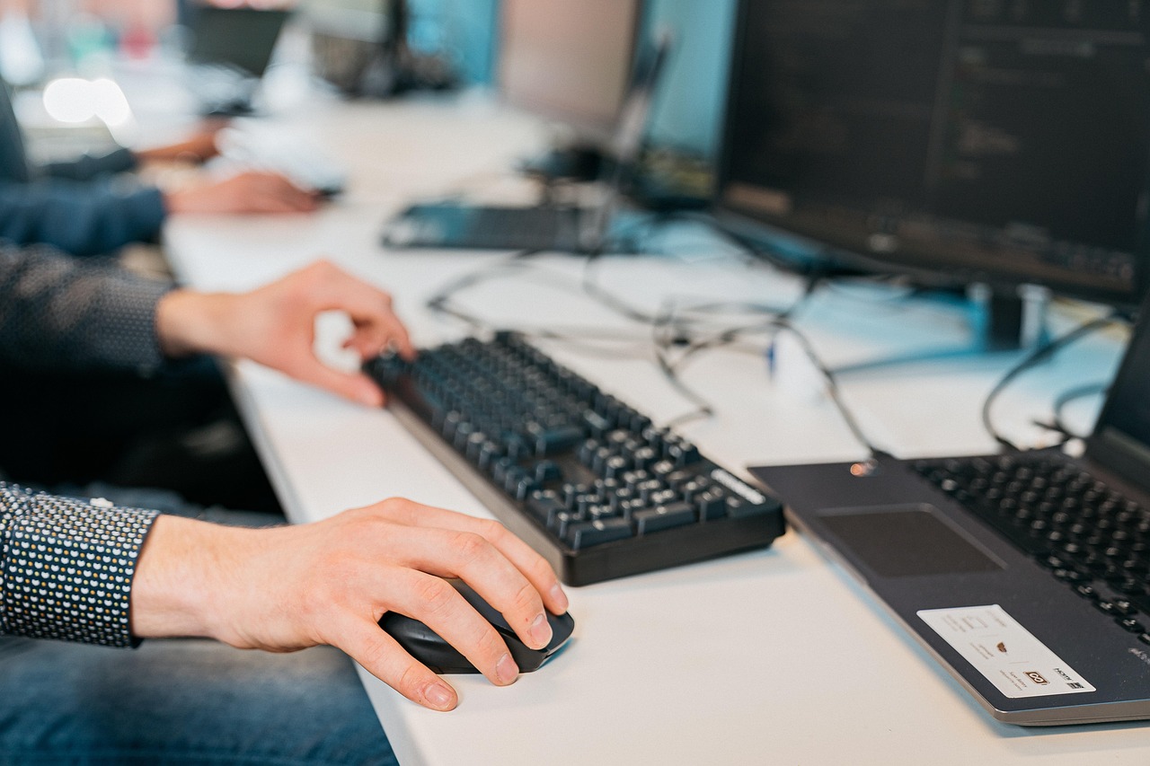 Close up image of technicians working on computers in the office